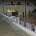 metal banister in raised seating in gym