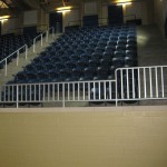 metal banister in raised seating in gym