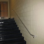 indoor stair rail on cinder block wall