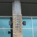 front view of glass metal decor pieces on stone pillar