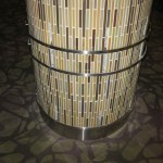 custom metal ornaments attached to tile on round column