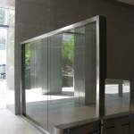 glass wall divider with metal frame inside hess tower at entrance