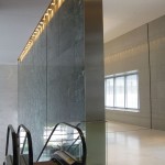 narrow metal wall panel on marble wall in hess tower