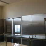 top of stianless steel kitchen door with windows and metal wall plates