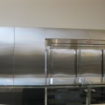 fabricated metal wall plates around kitchen fridge