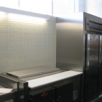 stainless steel fridge framing with tile wall