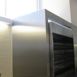 stainless steel fridge framing on tile wall