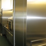 stainless steel wall with kitchen appliances and fridge