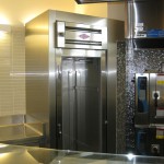 fabricated stainless steel door and walls on tile with appliances