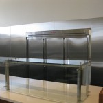 stainless steel fridge with glass and metal counter tops