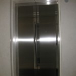 stainless steel elevator door frame on marble wall