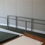custom metal railing at top of carpeted ramp