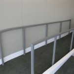 custom fabricated metal railing at top of carpeted ramp