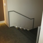 custom metal railing going up stairs against wall