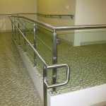 end of metal handrail and fittings on glass panels