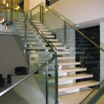 metal handrail on glass panel stairway