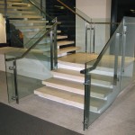 metal handrail on glass panel stairway