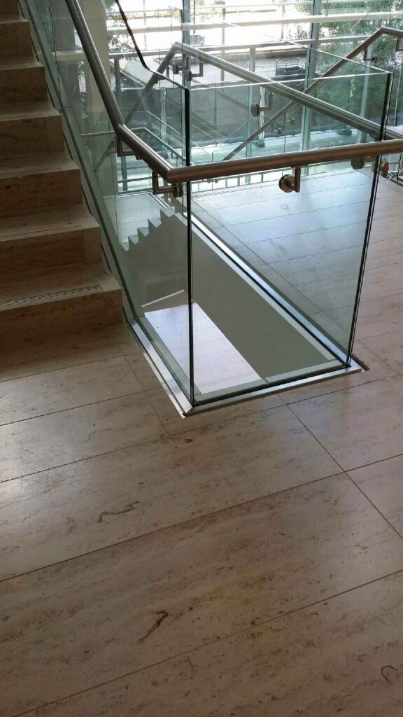 steel handrail cladding on glass stairway