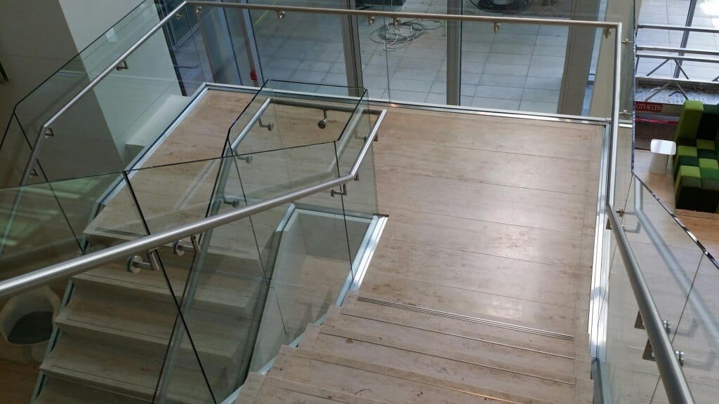 steel handrails on glass stairway